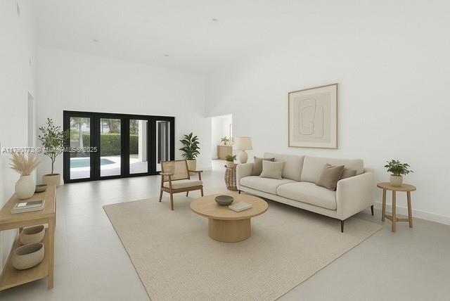 19601 E Saint Andrews Dr, Hialeah, FL 33015 - living room with a towering ceiling, french doors, and baseboards