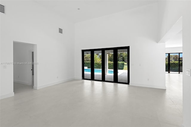 19601 E Saint Andrews Dr, Hialeah, FL 33015 - spare room with a towering ceiling, visible vents, and baseboards