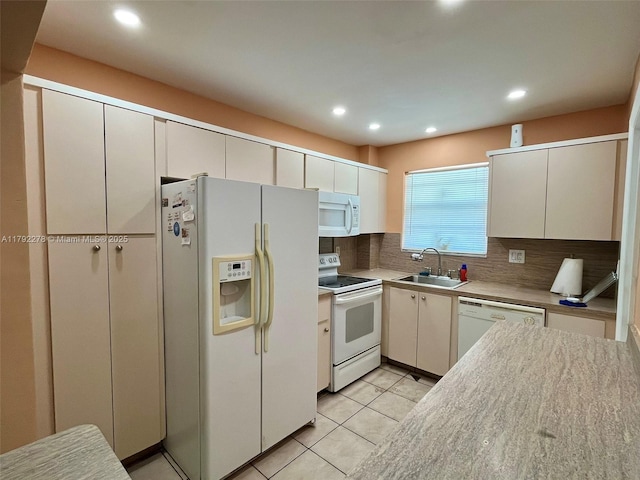 kitchen featuring a sink, light tile patterned flooring, recessed lighting, white appliances, and backsplash