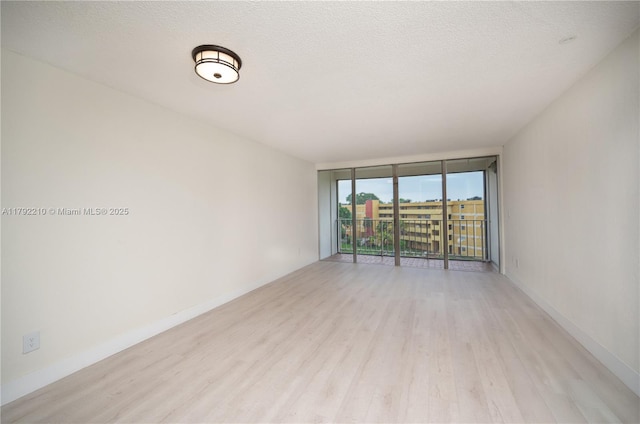 9210 Fontainebleau Blvd Unit 505, Miami, FL 33172 - unfurnished room with light wood-style floors, floor to ceiling windows, and baseboards