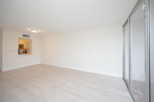 9210 Fontainebleau Blvd Unit 505, Miami, FL 33172 - spare room with light wood-style flooring, baseboards, and a sink