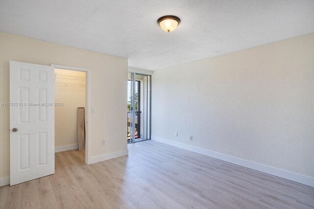9210 Fontainebleau Blvd Unit 505, Miami, FL 33172 - unfurnished bedroom with light wood-style floors, baseboards, and access to exterior