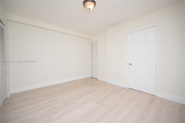 9210 Fontainebleau Blvd Unit 505, Miami, FL 33172 - unfurnished bedroom with light wood-style floors, a closet, and baseboards