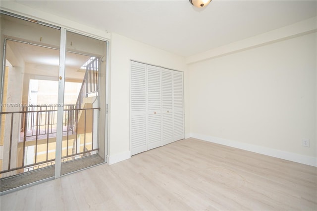 9210 Fontainebleau Blvd Unit 505, Miami, FL 33172 - unfurnished bedroom featuring access to outside, wood finished floors, a closet, and baseboards