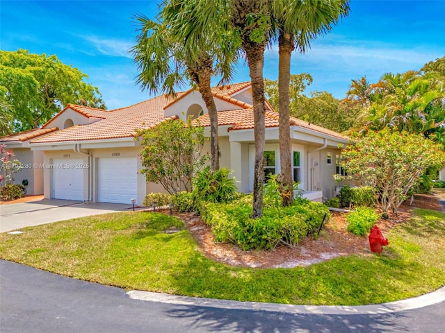 11069 Rios Rd, Boca Raton, FL 33498 - mediterranean / spanish house with a tiled roof, a garage, a front lawn, concrete driveway, and stucco siding