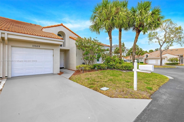 11069 Rios Rd, Boca Raton, FL 33498 - mediterranean / spanish-style home featuring stucco siding, an attached garage, driveway, and a front lawn