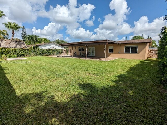 7431 SW 135th Ave, Miami, FL 33183 - back of property featuring fence, stucco siding, a lawn, and a patio area