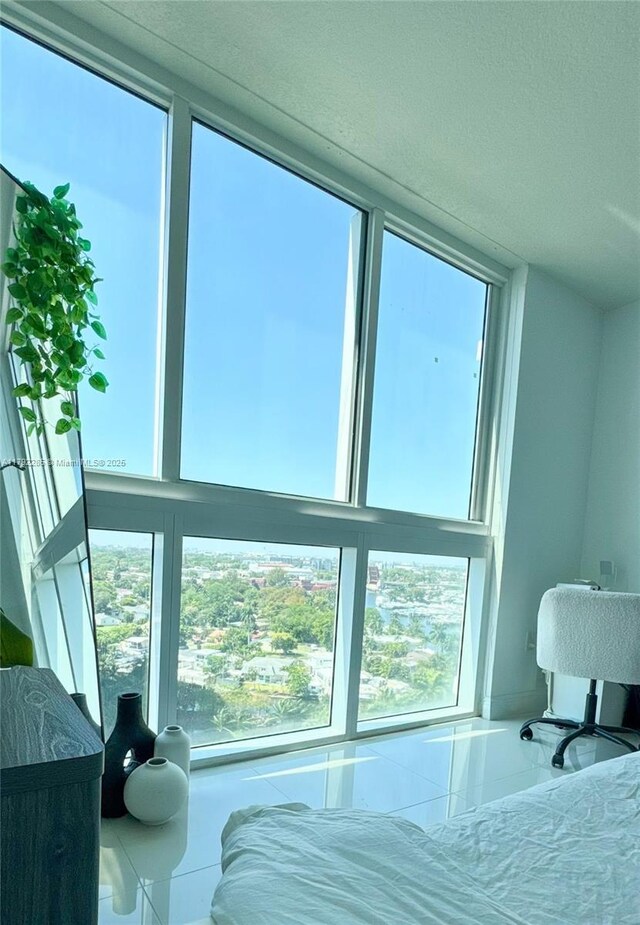 bedroom featuring a textured ceiling and multiple windows