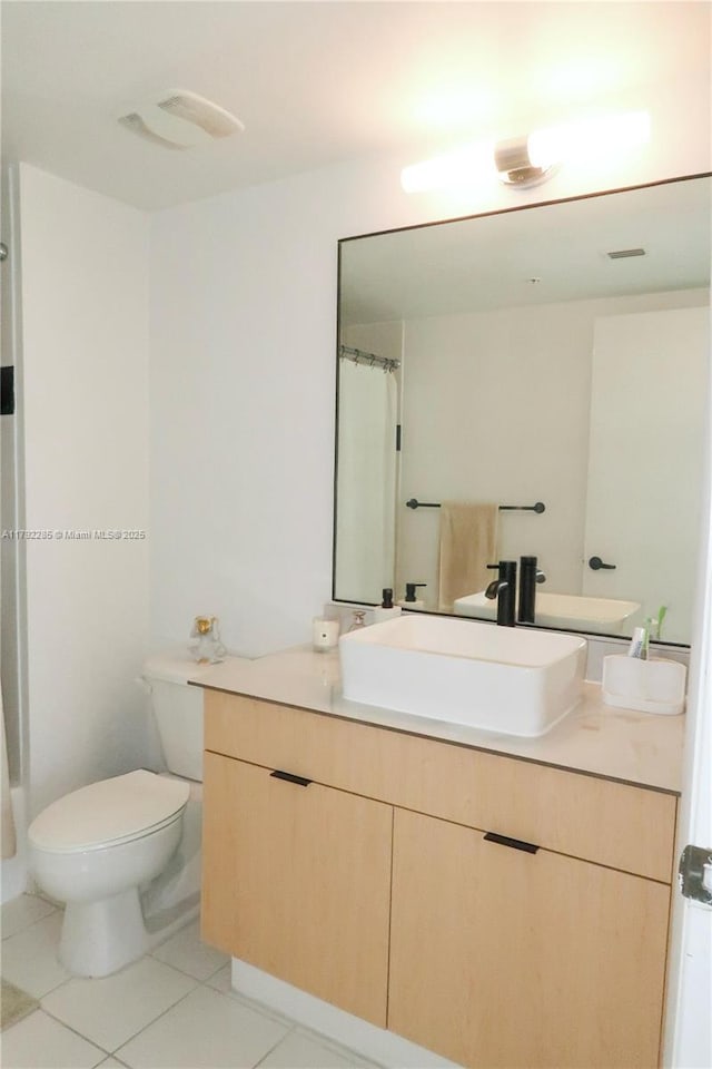 bathroom featuring tile patterned floors, toilet, and vanity