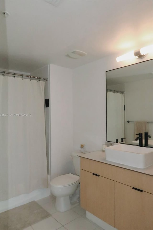 bathroom with curtained shower, tile patterned floors, toilet, and vanity