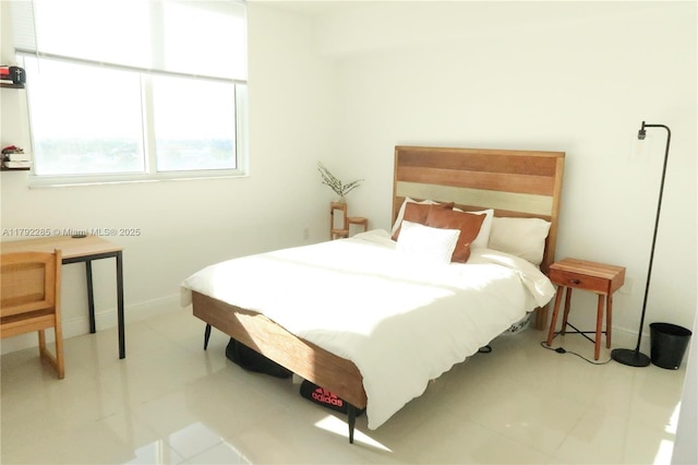 bedroom with baseboards and tile patterned floors