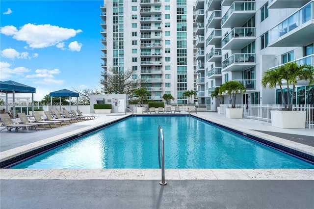 pool with fence and a patio area