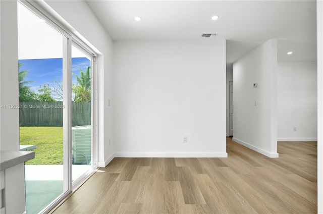 unfurnished room with visible vents, recessed lighting, light wood finished floors, and baseboards