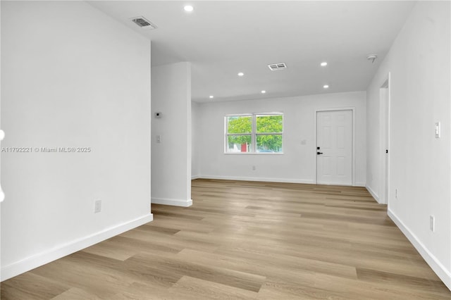 empty room featuring recessed lighting, visible vents, light wood-style flooring, and baseboards