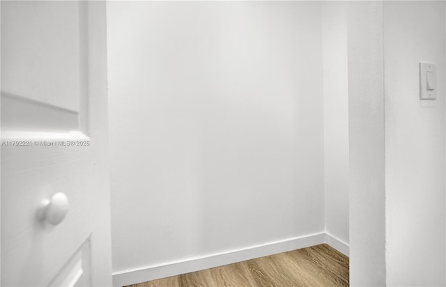 interior space with wood finished floors and baseboards
