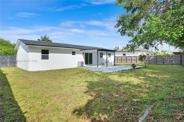 back of house featuring cooling unit, a lawn, stucco siding, and a patio area