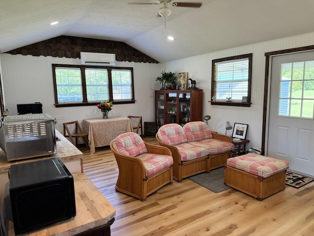 3725 SW 162nd St, Gainesville, FL 32618 - living room with an AC wall unit, light wood-style floors, a ceiling fan, and vaulted ceiling