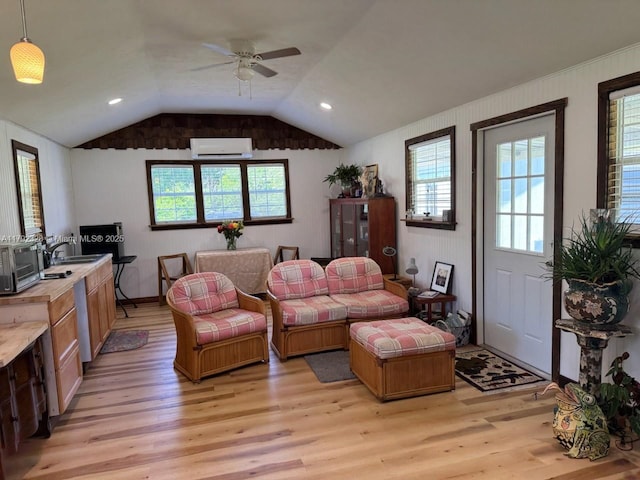 3725 SW 162nd St, Gainesville, FL 32618 - living area featuring a wall unit AC, light wood-style flooring, a ceiling fan, and lofted ceiling