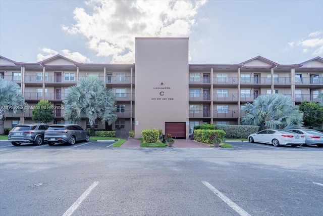 view of building exterior with uncovered parking