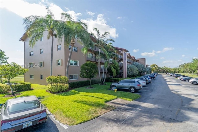 view of building exterior with uncovered parking