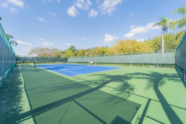 view of sport court featuring fence