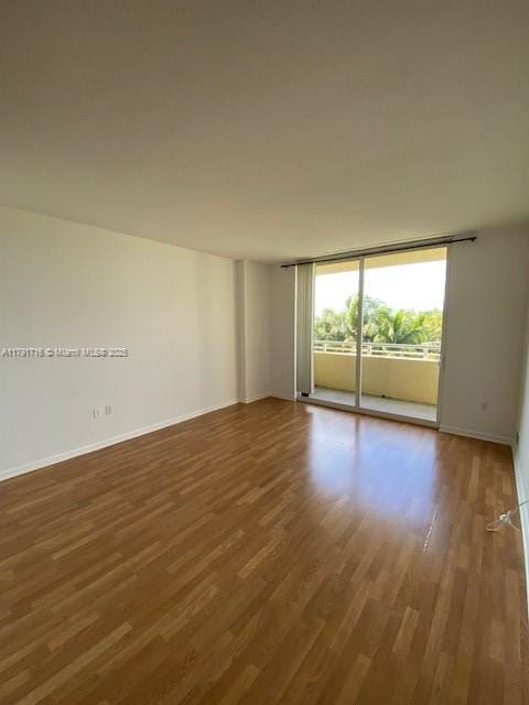 2775 NE 187th St Unit 311, Aventura, FL 33180 - empty room with wood finished floors and baseboards