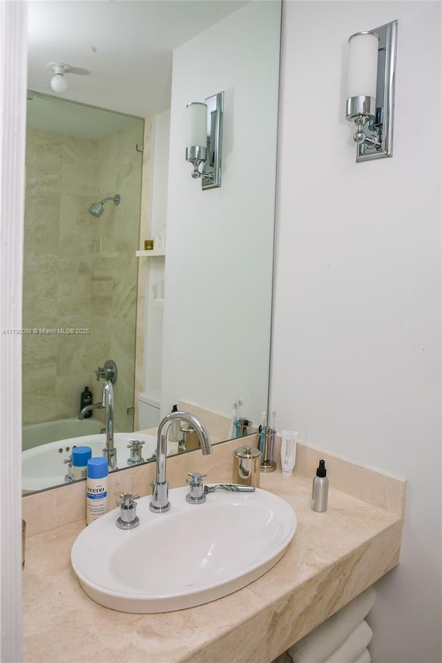 full bath with toilet, shower / washtub combination, and a sink