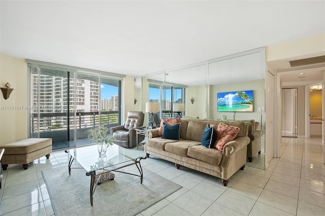 living room featuring light tile patterned floors and floor to ceiling windows