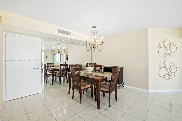 dining room with light tile patterned floors, an inviting chandelier, baseboards, and visible vents