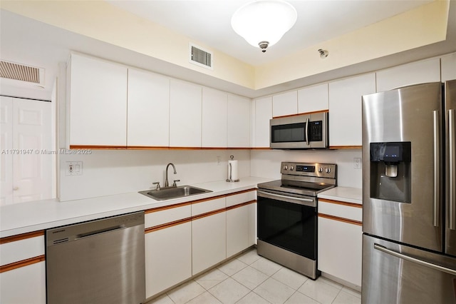kitchen featuring appliances with stainless steel finishes, visible vents, light countertops, and a sink