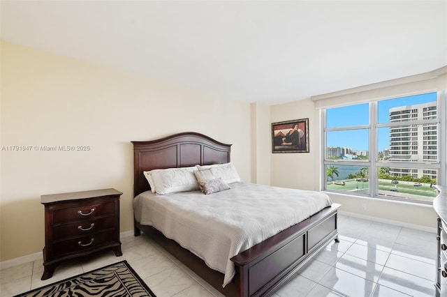 bedroom with a view of city and baseboards