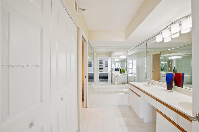 bathroom with a sink, double vanity, a stall shower, a bath, and tile patterned floors