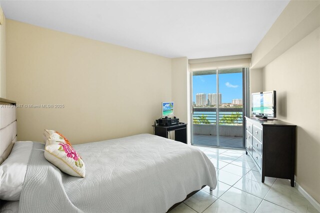 bedroom featuring light tile patterned flooring, access to exterior, and baseboards