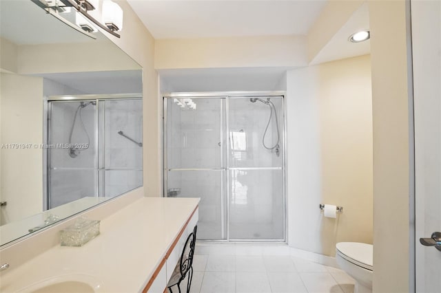 full bathroom featuring a stall shower, toilet, and vanity