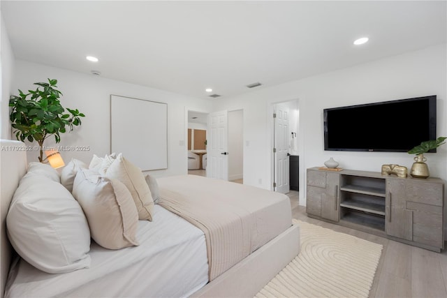 bedroom with recessed lighting, light wood finished floors, and visible vents