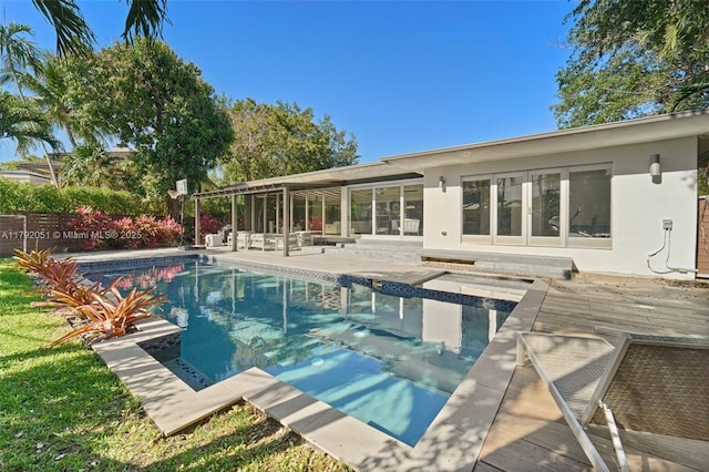 pool with a jacuzzi and a patio area