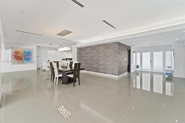 dining area with baseboards, visible vents, and light tile patterned flooring