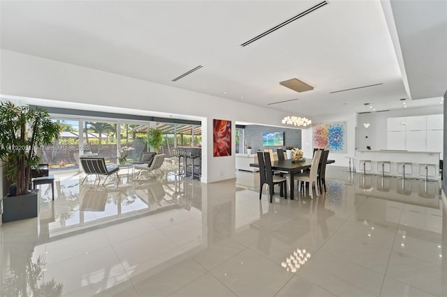 dining area featuring light tile patterned floors and a chandelier