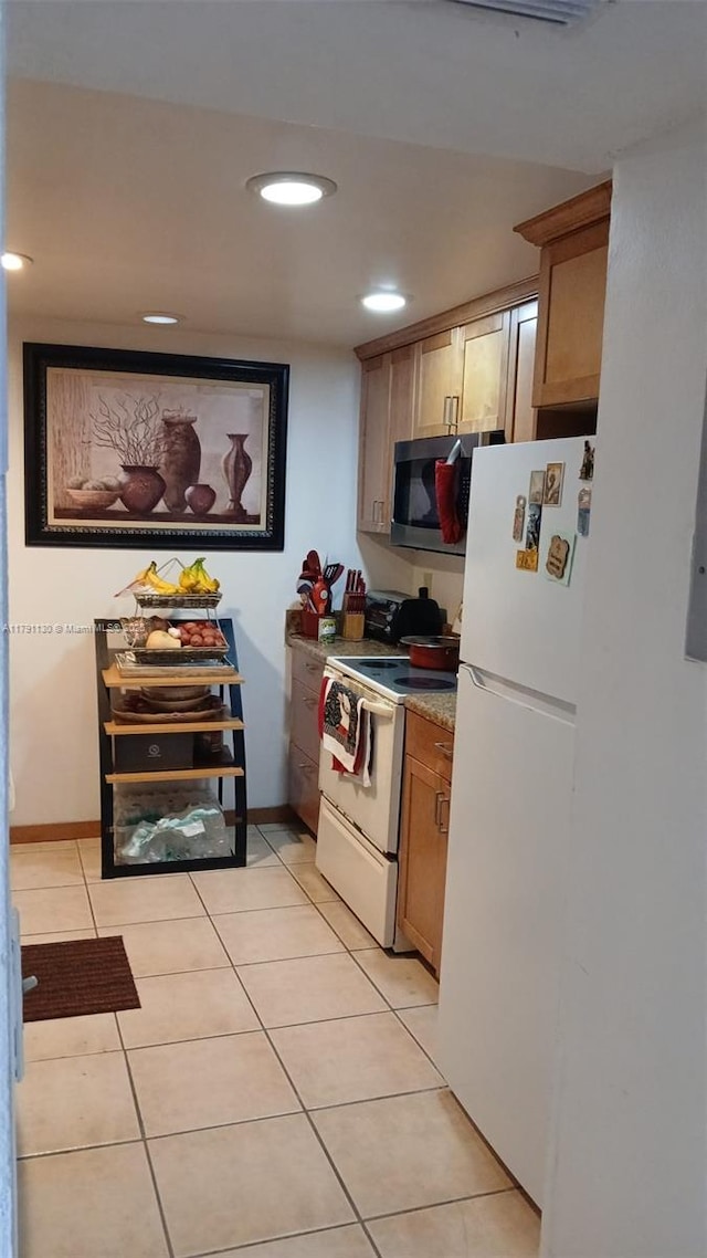 8240 SW 210th St Unit 313, Cutler Bay, FL 33189 - kitchen with white appliances, light tile patterned floors, recessed lighting, brown cabinets, and light countertops