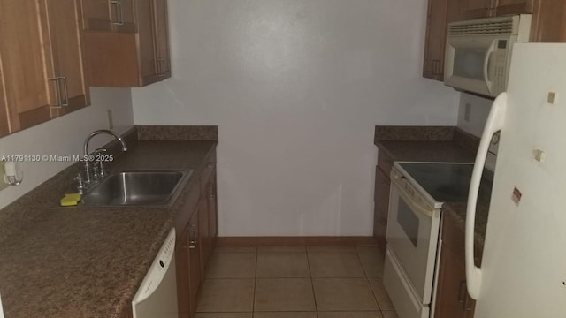 8240 SW 210th St Unit 313, Cutler Bay, FL 33189 - kitchen with light tile patterned floors, dark countertops, a sink, and white appliances