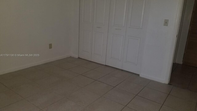 8240 SW 210th St Unit 313, Cutler Bay, FL 33189 - unfurnished bedroom with light tile patterned floors and a closet