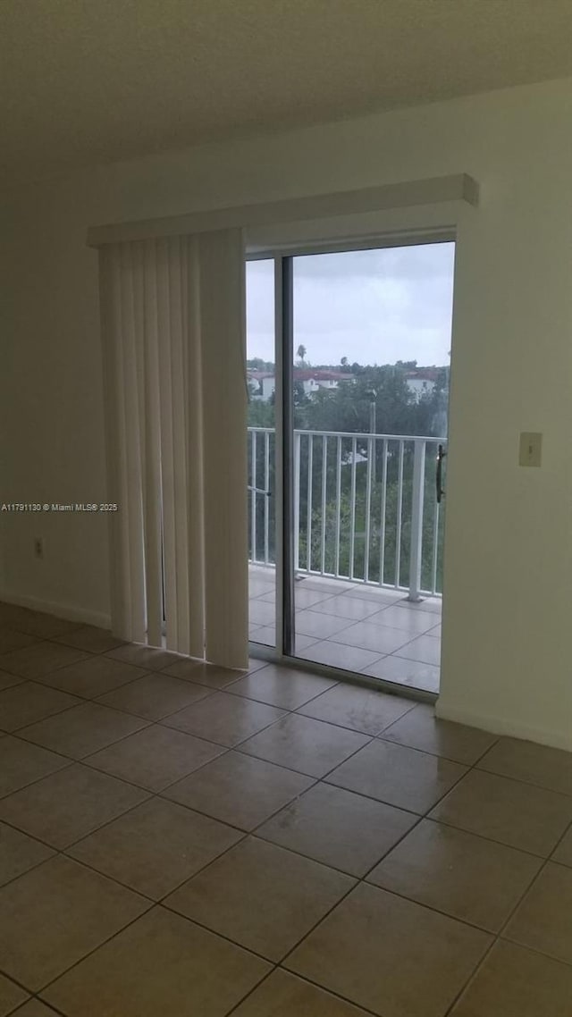 8240 SW 210th St Unit 313, Cutler Bay, FL 33189 - tiled spare room featuring baseboards