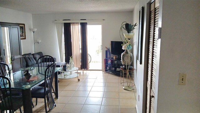 8240 SW 210th St Unit 313, Cutler Bay, FL 33189 - dining area with light tile patterned floors and a textured ceiling