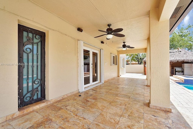 view of patio featuring ceiling fan, a fenced backyard, and an outdoor pool