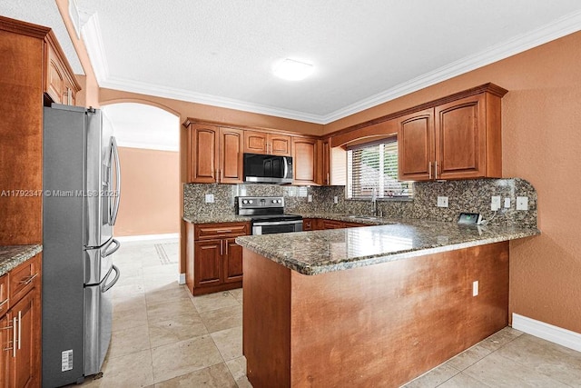 kitchen featuring arched walkways, decorative backsplash, appliances with stainless steel finishes, a peninsula, and crown molding