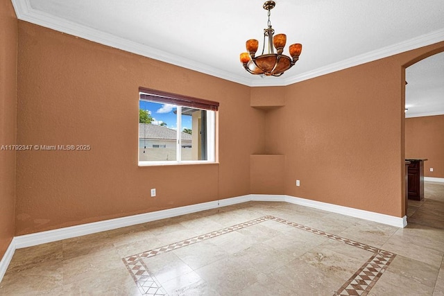 spare room featuring a notable chandelier, baseboards, ornamental molding, and arched walkways