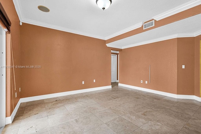 empty room featuring visible vents, ornamental molding, and baseboards