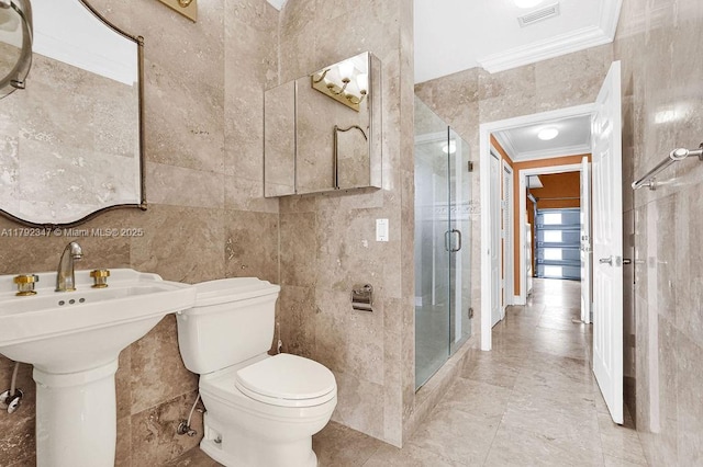 bathroom featuring visible vents, a stall shower, toilet, ornamental molding, and tile walls