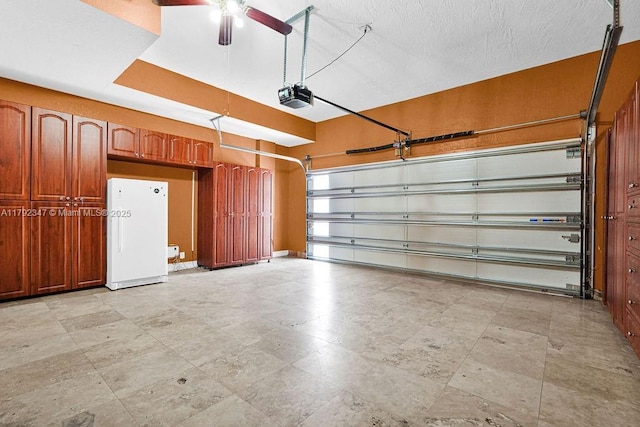 garage featuring a garage door opener, a ceiling fan, and freestanding refrigerator