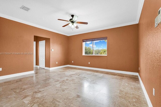 spare room with ornamental molding, ceiling fan, and baseboards